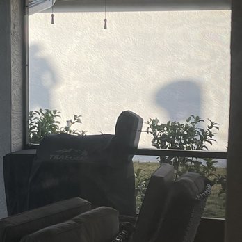 Mid-Coast Roofing - Shadows of workers on the roof. I'm not going outside because old shingles are raining coming down that they take off the roof! - Roofing Near Me - Lakewood Ranch, Florida