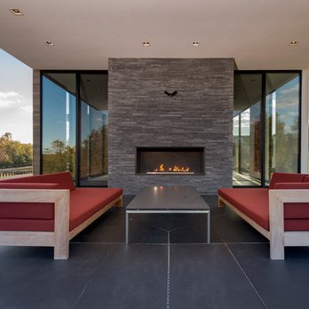 DJR Contracting - a modern outdoor living room with a fireplace - General Contractors Near Me DJR Contracting - a modern outdoor living room with a fireplace - General Contractors Near Me