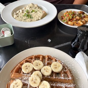 Highland Morning - Biscuits and Gravy with loaded potatoes and a Belgian waffle with bananas. - Breakfast & Brunch Near Me - Louisville, Kentucky Highland Morning - Biscuits and Gravy with loaded potatoes and a Belgian waffle with bananas. - Breakfast & Brunch Near Me - Louisville, Kentucky