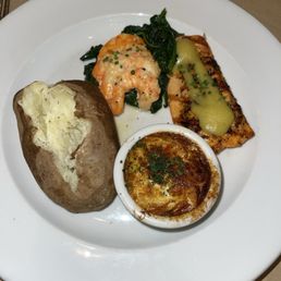 Salmon with baked potato, shrimp and spinach and crab imperial. Salmon with baked potato, shrimp and spinach and crab imperial.