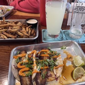 Two Dogs Taphouse - Pork Belly tacos, side of fries with fry sauce, upper corner fish tacos, empty cream ale, Ruzzo Peach's and Cream - Burgers Near Me - McMinnville, Oregon