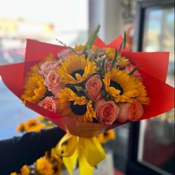 D&C Store Party Supply & Florist - Mix of sunflowers and orange roses.