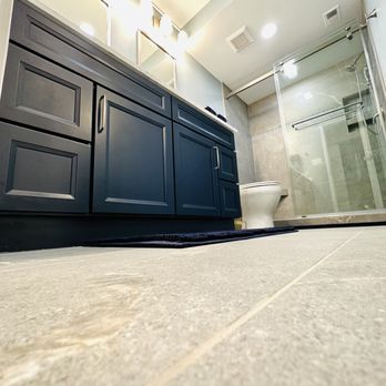 Tile Center - Navy blue vanity and grey tile that work together for a calming effect. - Kitchen & Bath Near Me - Gaithersburg, Maryland Tile Center - Navy blue vanity and grey tile that work together for a calming effect. - Kitchen & Bath Near Me - Gaithersburg, Maryland