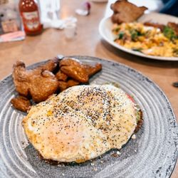 The Chalkboard Kitchen - Avocado toast: wheat toast, avocado, pickled red onion, feta, tomato and an egg + smashed potatoes on the side
