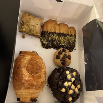 Paul & Jack Bakery & Cafe - Baklava (top left), Italian chocolate pistachio cookie (top right), mini brookie (middle), chocolate croissant, triple chocolate brookie - Desserts Near Me - Wake Forest, North Carolina Paul & Jack Bakery & Cafe - Baklava (top left), Italian chocolate pistachio cookie (top right), mini brookie (middle), chocolate croissant, triple chocolate brookie - Desserts Near Me - Wake Forest, North Carolina