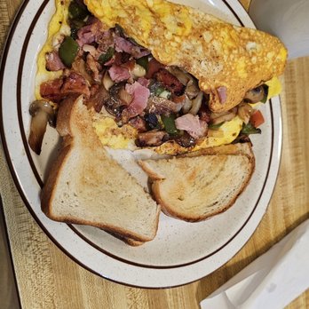 Silver Leaf Diner - an omelet and toast on a plate - A breakfast plate features a folded omelet filled with vegetables, ham, and mushrooms, accompanied by two slices of toasted bread. - Diners Near Me - De Kalb Junction, New York