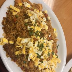 Rice with chicken, egg, steak, shrimp, cilantro, peas, and carrots.