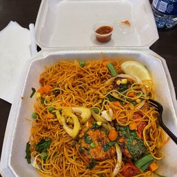 a takeout container with noodles and vegetables a takeout container with noodles and vegetables