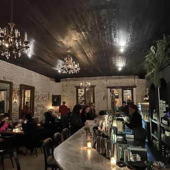 Cane and Table - people sitting at tables in a restaurant - Cocktail Bars Near Me - New Orleans, Louisiana