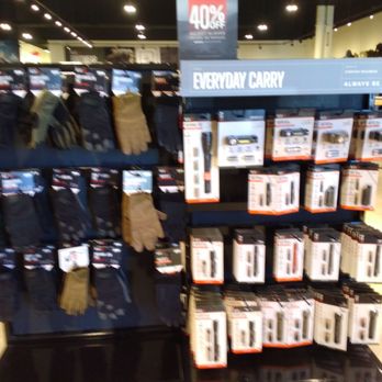 5.11 Tactical - Gloves and flashlights. - Shelf with tactical gloves and flashlights at 5.11 Tactical in Albuquerque, NM, with signage indicating discounts and product categories. - Outdoor Gear Near Me - Albuquerque, New Mexico