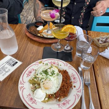 El Camino - Chilaquiles verde with chorizo and mimosa tower in the back! - Mexican Near Me - Seattle, Washington El Camino - Chilaquiles verde with chorizo and mimosa tower in the back! - Mexican Near Me - Seattle, Washington