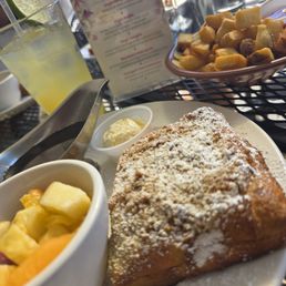 Baklava French toast, fruit, potatoes, and mocktail Baklava French toast, fruit, potatoes, and mocktail