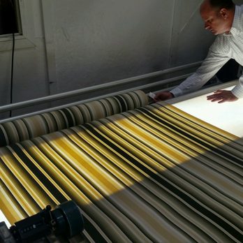 The Miami Corporation - Our Sales Manager, Dante, rolling out some Tempotest awning fabric on a light table. - Fabric Stores Near Me - Cincinnati, Ohio The Miami Corporation - Our Sales Manager, Dante, rolling out some Tempotest awning fabric on a light table. - Fabric Stores Near Me - Cincinnati, Ohio