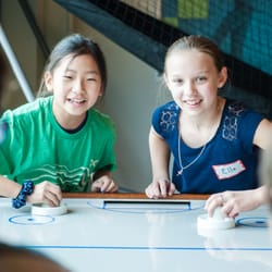 Chase Oaks Church - Sloan Creek Campus - Kids playing air hockey table