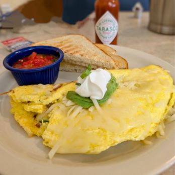 Ronnie's Restaurant - Cali omelette with sour cream and in house salsa, sourdough bread. - Breakfast & Brunch Near Me - Lenexa, Kansas Ronnie's Restaurant - Cali omelette with sour cream and in house salsa, sourdough bread. - Breakfast & Brunch Near Me - Lenexa, Kansas