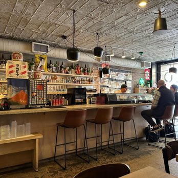 Oramen - a man sitting at a bar - Ramen Near Me - New York, New York