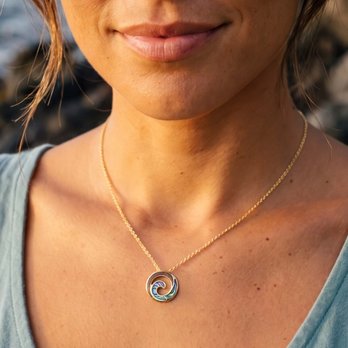 Na Hoku - Model wearing gold ocean wave pendant featuring Abalone and Koa wood on a gold chain - Jewelry Near Me - Honolulu, Hawaii Na Hoku - Model wearing gold ocean wave pendant featuring Abalone and Koa wood on a gold chain - Jewelry Near Me - Honolulu, Hawaii
