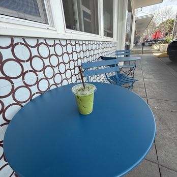 Naysayer Coffee Roasters - Enjoying my delicious Iced honeydew matcha in the little seating area outside - Coffee Roasteries Near Me - Napa, California