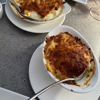 Arnold Palmer's Restaurant - These Homemade Scalloped Potatoes are craveable and insanely addicting. Next to it is the Palmer 's Mac & Cheese. Also ridiculously tasty - American Near Me - La Quinta, California Arnold Palmer's Restaurant - These Homemade Scalloped Potatoes are craveable and insanely addicting. Next to it is the Palmer 's Mac & Cheese. Also ridiculously tasty - American Near Me - La Quinta, California