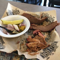 We got the three meat platter ,brisket ,pulled pork and polish sausage with baked beans and potato salad We got the three meat platter ,brisket ,pulled pork and polish sausage with baked beans and potato salad