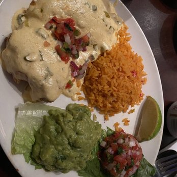 Mi Cocina - Chimichanga covered in queso with guacamole - Mexican Near Me - Fort Worth, Texas