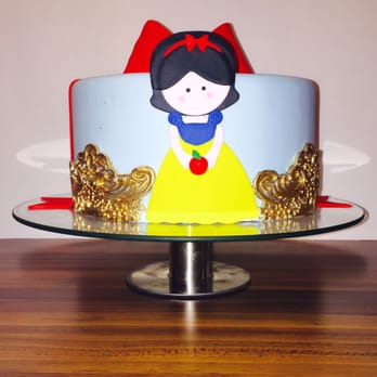 Designer Sweets - a snow white cake with a red bow - Cupcakes Near Me Designer Sweets - a snow white cake with a red bow - Cupcakes Near Me