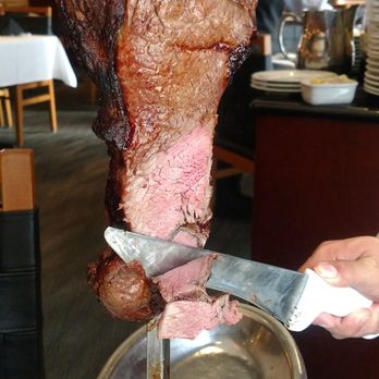 Fogo de Chão - Meat carving at the table to one's choice (rare, medium, well done). - Brazilian Near Me - Denver, Colorado