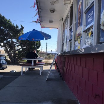 B&J Drive - In - a man sitting at a table under an umbrella - Burgers Near Me - Ventura, California B&J Drive - In - a man sitting at a table under an umbrella - Burgers Near Me - Ventura, California