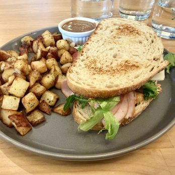 Toasted Brunch Bar + Café - Space Pig sandwich with a side of home fries and gravy - Breakfast & Brunch Near Me - Beavercreek, Ohio Toasted Brunch Bar + Café - Space Pig sandwich with a side of home fries and gravy - Breakfast & Brunch Near Me - Beavercreek, Ohio