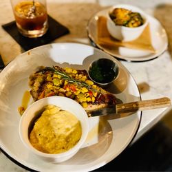 KBC - Bone in pork chop with succotash, Gouda, smoked grits, brussels sprouts in pepper jelly