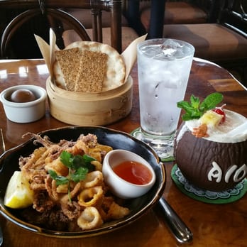 Trader Vic's - Calamari, crackers with coconut butter and Puerto principe drink. - Hawaiian Near Me - Emeryville, California Trader Vic's - Calamari, crackers with coconut butter and Puerto principe drink. - Hawaiian Near Me - Emeryville, California