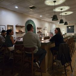 Campo Bar & Bottle - High top tables and wine menu straight back