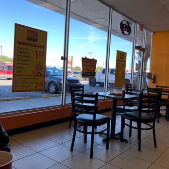 Las Quesadillas - a man sitting at a table in a restaurant - Mexican Near Me - Houston, Texas