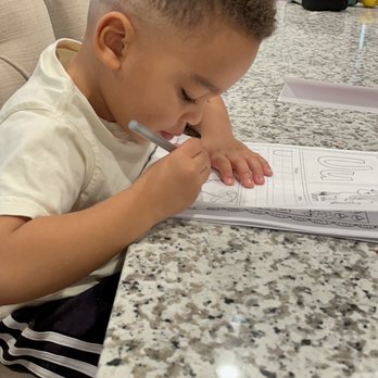 Kinderbugs Preparatory School - Gilbert - He loves his homework! - Elementary Schools Near Me - Gilbert, Arizona