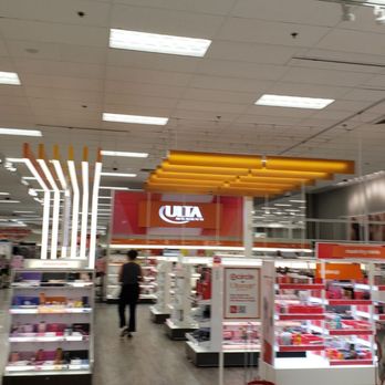 Target - The image shows the interior of a Target retail store, featuring shelves filled with various products, bright lighting, and signage including the Target logo. Customers are seen walking and shopping within the store, which has a modern, organized layout with overhead lighting and display fixtures. - Department Stores Near Me - Sunrise, Florida