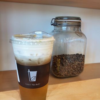 Brew Tea Bar - Jasmine Sea Salt Latte ($4.75 large) next to some jasmine pearls displayed on the shelf - Bubble Tea Near Me - Las Vegas, Nevada