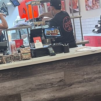 Urban Bird Hot Chicken - Employee drinking behind counter - Chicken Shop Near Me - Katy, Texas