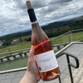 Willamette Valley Vineyards - a hand holding a bottle of wine - Wineries Near Me - Turner, Oregon Willamette Valley Vineyards - a hand holding a bottle of wine - Wineries Near Me - Turner, Oregon