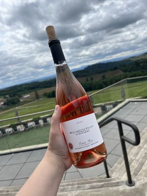 Photo of Willamette Valley Vineyards - Turner, OR, US. a hand holding a bottle of wine