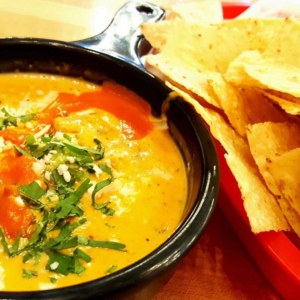 Torchy's Tacos - Close up of the green chile queso! Mmm... - Tex-Mex Near Me - Denver, Colorado Torchy's Tacos - Close up of the green chile queso! Mmm... - Tex-Mex Near Me - Denver, Colorado