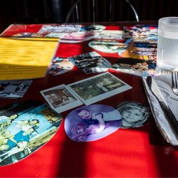 Lockport Inc - Dining table with pictures from frequent customers.