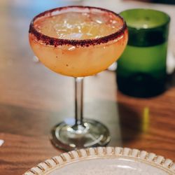 NOM Mexican Table + Tequila Bar - Mango margarita with hibiscus sugar rim