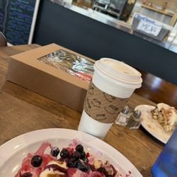 Waffle with fresh berries and cream and baked goods for the road.