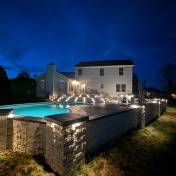 Green Home Improvements - Large scale custom patio, deck, stone retaining wall with lights throughout - General Contractors Near Me Green Home Improvements - Large scale custom patio, deck, stone retaining wall with lights throughout - General Contractors Near Me