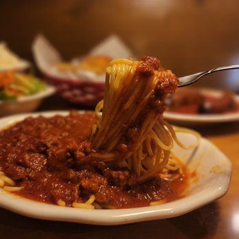 Vince's Spaghetti - a plate of spaghetti being held by a fork - Italian Near Me - Rancho Cucamonga, California Vince's Spaghetti - a plate of spaghetti being held by a fork - Italian Near Me - Rancho Cucamonga, California