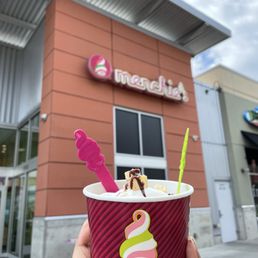 a hand holding a cup of ice cream a hand holding a cup of ice cream