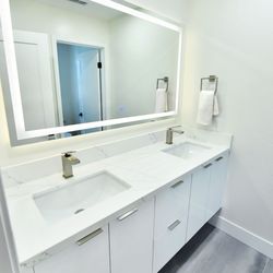 Q Kitchen & Bath - Dual sink Bathroom (European style custom floating cabinets, Led mirrors, paint, large porcelain tiles)