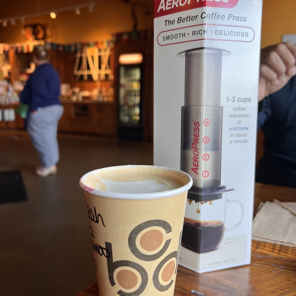 Coffee By Design - a cup of coffee on a table - Coffee Roasteries Near Me - Portland, Maine