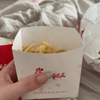 Chick-fil-A - ows a hand holding a box of fries - Fast Food Near Me - Springfield, Illinois