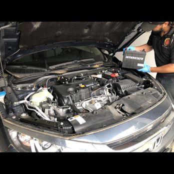 Car Battery Seattle - Technician installing Interstate battery on a Honda Accord - Roadside Assistance Near Me - Seattle, Washington